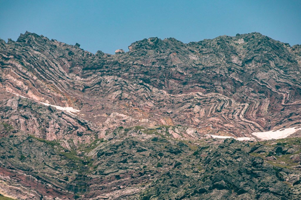 A close-up shot of wild folds in the sedimentary layers of the mountains west of Sperry Glacier. 