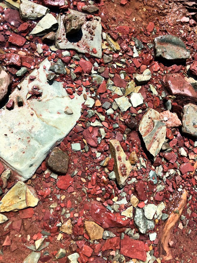 A mix of bright red and pale green rocks fill the frame. 