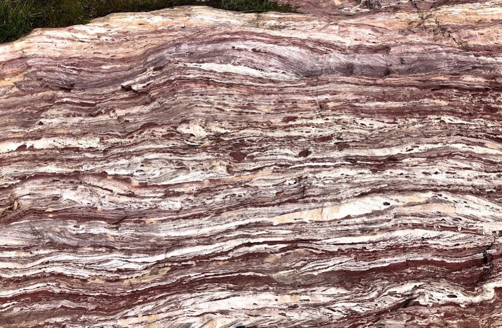 Cross-bedded argillite and quartzite is shown with layers running from side to side. Layers are very thin and very many.
