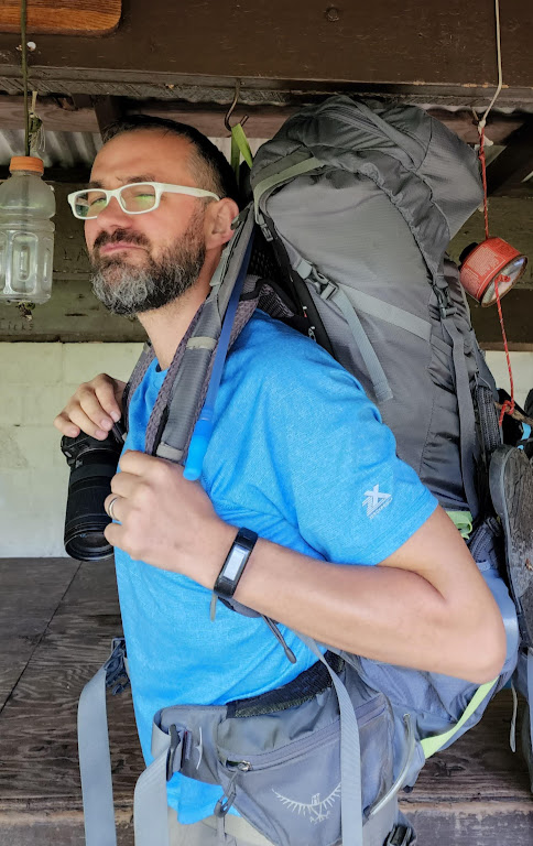 Dustin appears to be wearing his backpack in the center of the photo, but upon closer inspection you can see that his backpack is still hanging on a hook attached to the roof of the shelter. Dustin is very tall.