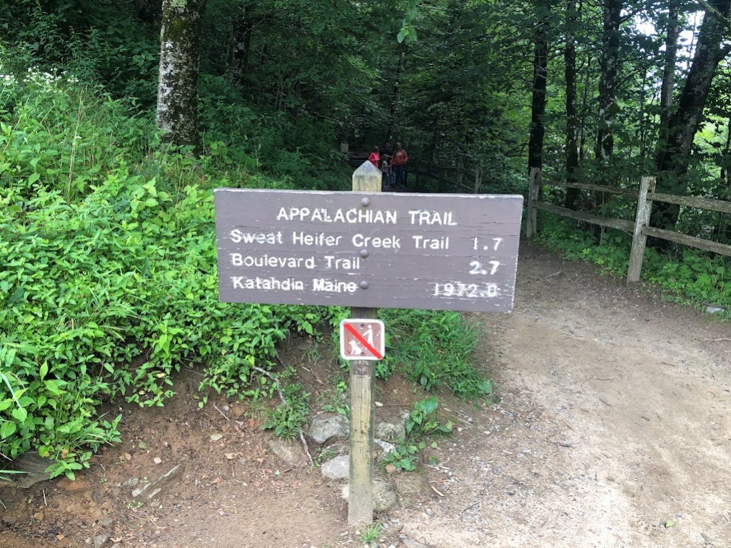 A trail sign reading:

APPALACHIAN TRAIL
Sweet Heifer Creek Trail 1.7
Boulevard Trail 2.7
Katahdin Maine 1972.0
No Dogs