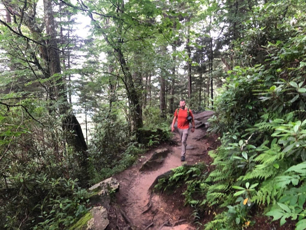 Dustin, center, walks up a trail in the woods.