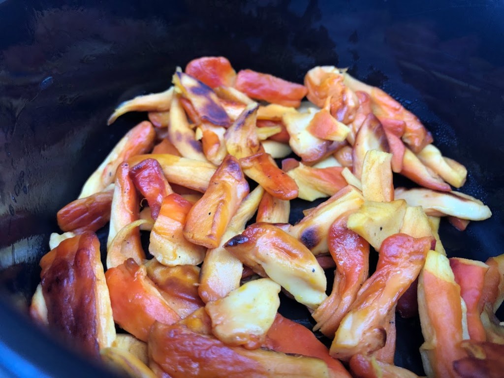 A closeup of chicken-of-the-woods mushrooms cooking in a pot. 
