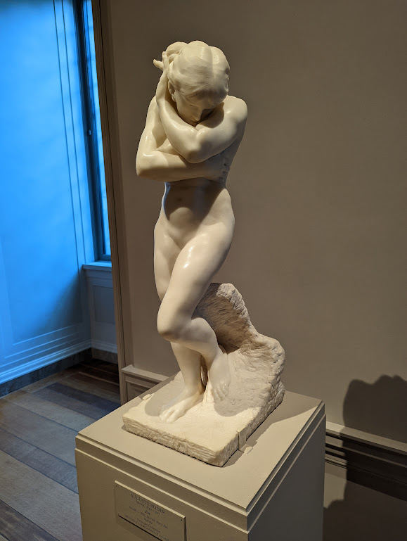 A marble sculpture of a nude female, arms wrapped protectively around her torso and neck, face bowed down with shame. (I believe it is a depiction of Eve being cast out of Eden, but I didn't make a proper note). 