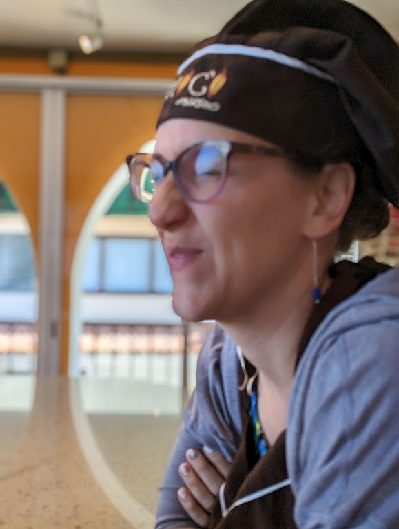 A closeup of Laura's face in profile, looking left, rather out of focus. Her eyes are closed and her nose is all scrunched up in distaste.